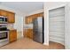 Kitchen with stainless steel refrigerator, ample cabinetry, and laminate wood flooring at 9728 Batesville Dr, Raleigh, NC 27617