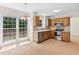 Eat-in kitchen with stainless appliances, tile backsplash, and a large window view to the backyard at 9728 Batesville Dr, Raleigh, NC 27617