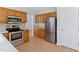 Kitchen with stainless steel appliances, wood cabinets, and ample counter space at 9728 Batesville Dr, Raleigh, NC 27617