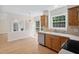 Bright kitchen with wood cabinets, modern appliances, and a view to the backyard at 9728 Batesville Dr, Raleigh, NC 27617