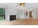 Open living room with fireplace, access to kitchen, and backyard views at 9728 Batesville Dr, Raleigh, NC 27617