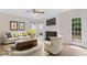 Inviting living room with a fireplace, light-colored furniture, and a door leading to the outside at 9728 Batesville Dr, Raleigh, NC 27617
