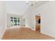 Bright living room with hardwood floors, large window, and vaulted ceilings at 9728 Batesville Dr, Raleigh, NC 27617
