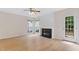 Bright living room with a fireplace, large windows and an exit to the backyard at 9728 Batesville Dr, Raleigh, NC 27617