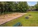 Community playground with swing sets, picnic tables and a volleyball court and shade trees at 9728 Batesville Dr, Raleigh, NC 27617