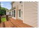 Wooden deck and exterior view of home with beige horizontal siding and bay windows at 9728 Batesville Dr, Raleigh, NC 27617