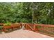 Back deck with wooden railing, planter box, and access gate surrounded by trees at 1003 Blackberry Ln, Durham, NC 27712