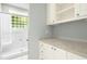 Bathroom features white vanity and cabinets, tile floors, and glass-enclosed shower at 1003 Blackberry Ln, Durham, NC 27712