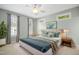 Cozy main bedroom with many windows, ceiling fan, carpet, and custom curtains at 1003 Blackberry Ln, Durham, NC 27712