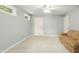 Neutral bedroom with ceiling fan, natural light, and comfortable seating at 1003 Blackberry Ln, Durham, NC 27712
