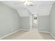 Bright bedroom with a ceiling fan, neutral carpet, light walls, and an arched window at 1003 Blackberry Ln, Durham, NC 27712