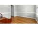 Light-filled, empty room with hardwood floors and white trim at 1003 Blackberry Ln, Durham, NC 27712
