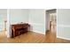 Bright, empty room with hardwood floors and piano at 1003 Blackberry Ln, Durham, NC 27712