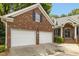 Brick home features a spacious two-car garage with a private driveway at 1003 Blackberry Ln, Durham, NC 27712