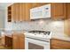 Bright kitchen with granite countertops, wooden cabinets, stainless steel microwave and gas cooktop at 1003 Blackberry Ln, Durham, NC 27712
