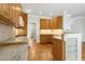 Bright kitchen with granite countertops, wooden cabinets, stainless steel appliances and hardwood floors at 1003 Blackberry Ln, Durham, NC 27712