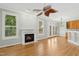 Open-concept living area with fireplace, hardwood floors, and access to a kitchen at 1003 Blackberry Ln, Durham, NC 27712