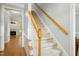 Carpeted staircase with wood railing leading to the upper level at 1003 Blackberry Ln, Durham, NC 27712