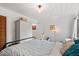 Bright bedroom boasts striped bedding, wardrobe, and natural light from a window at 1009 Iredell St # D, Durham, NC 27705