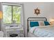Bedroom close-up shows quaint desk by a large window, iron bed frame and natural lighting at 1009 Iredell St # D, Durham, NC 27705