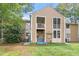 Exterior of the home featuring balconies, backyard area, and well-kept lawn at 1009 Iredell St # D, Durham, NC 27705
