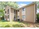 Rear exterior of a home with a covered balcony and patio, surrounded by trees and foliage at 1009 Iredell St # D, Durham, NC 27705