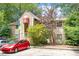Charming home exterior with a covered entrance, surrounded by mature trees and greenery at 1009 Iredell St # D, Durham, NC 27705