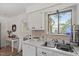 Kitchen features white cabinets, tile backsplash, stainless steel sink, and hardwood flooring at 1009 Iredell St # D, Durham, NC 27705