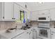 Kitchen has bright lighting, white cabinets, stainless steel sink, and natural lighting at 1009 Iredell St # D, Durham, NC 27705
