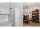 Spacious kitchen with white appliances, white cabinets, hardwood flooring, and views of dining room at 1009 Iredell St # D, Durham, NC 27705