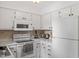 Traditional style kitchen features white appliances and cabinetry at 1009 Iredell St # D, Durham, NC 27705