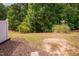 Backyard with lawn and wooded area beyond the fence at 1016 Kingston Grove Dr, Cary, NC 27519