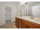 Bathroom featuring a double sink vanity, framed mirror, and a glass-enclosed shower at 1016 Kingston Grove Dr, Cary, NC 27519