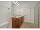 Bathroom featuring a double sink vanity, framed mirror, and a glass-enclosed shower at 1016 Kingston Grove Dr, Cary, NC 27519