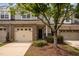 Charming townhome with a brick and siding exterior, two-car garage, and well-maintained landscaping at 1016 Kingston Grove Dr, Cary, NC 27519