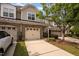 Charming townhome with a brick and siding exterior, two-car garage, and well-maintained landscaping at 1016 Kingston Grove Dr, Cary, NC 27519
