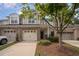 Charming townhome with a brick and siding exterior, two-car garage, and well-maintained landscaping at 1016 Kingston Grove Dr, Cary, NC 27519