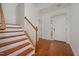 Bright foyer with hardwood floors, staircase, and entry door at 1016 Kingston Grove Dr, Cary, NC 27519