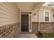 A close-up of the front door with sidelight, and address number at 1016 Kingston Grove Dr, Cary, NC 27519