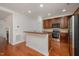 Kitchen features hardwood floors, stainless appliances and breakfast bar at 1016 Kingston Grove Dr, Cary, NC 27519