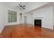 Open living room features hardwood floors, large windows, fireplace, and high ceilings at 1016 Kingston Grove Dr, Cary, NC 27519