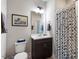 Bathroom with a dark wood vanity and a shower with a modern blue and white patterned curtain at 10310 Sablewood Dr # 115, Raleigh, NC 27617
