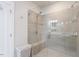 Bathroom features glass shower, bench seat, and light gray shower surround at 10310 Sablewood Dr # 115, Raleigh, NC 27617