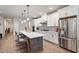 Modern kitchen with white cabinets, stainless steel appliances, a large island, and breakfast bar seating at 10310 Sablewood Dr # 115, Raleigh, NC 27617