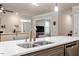 Kitchen island features double sink, dishwasher, and open view to living room at 10310 Sablewood Dr # 115, Raleigh, NC 27617