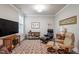 Cozy living room featuring plush seating, a patterned rug, and ample natural light at 10310 Sablewood Dr # 115, Raleigh, NC 27617
