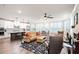 Open-concept living area showcasing hardwood floors, a ceiling fan, and a cozy seating arrangement at 10310 Sablewood Dr # 115, Raleigh, NC 27617