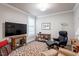 Cozy living room features TV, dark accent walls, and comfortable seating at 10310 Sablewood Dr # 115, Raleigh, NC 27617