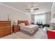 Bright main bedroom with king bed, ceiling fan, and seating area near the window at 10310 Sablewood Dr # 115, Raleigh, NC 27617
