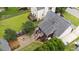 Aerial view of a home's backyard featuring a stone fire pit, wood pile and screened in porch at 1033 Mills St, Raleigh, NC 27608